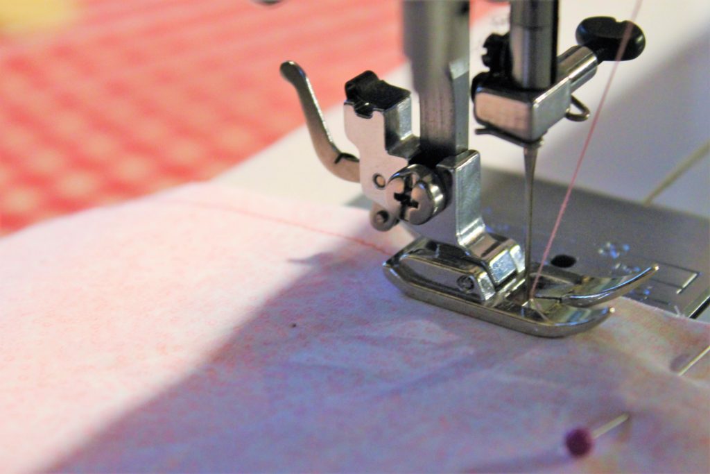 sewing pink thread through pink fabrics with a sewing machine