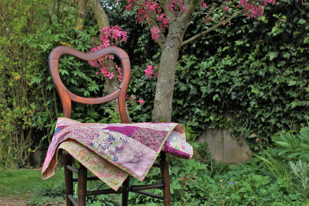 pink patchwork quilt on a chair in garden