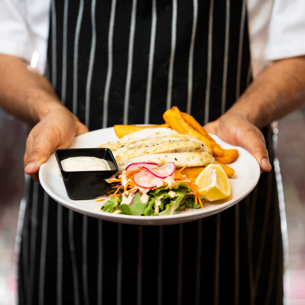 masterchef holding plate of food